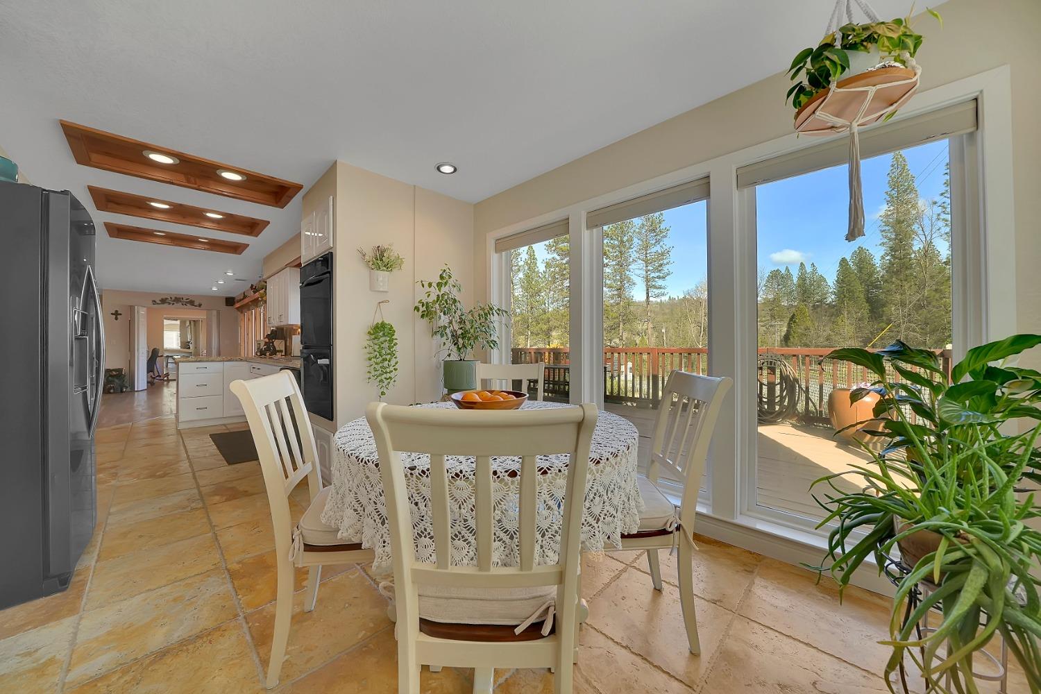301 Bald Mountain Road West Point, CA 95255 - Photo 4 of 55 a view of a dining room with furniture large windows and wooden floor