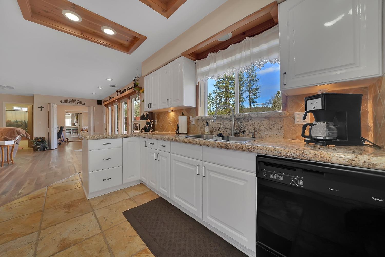 301 Bald Mountain Road West Point, CA 95255 - Photo 9 of 55 a kitchen with granite countertop a sink stainless steel appliances and cabinets