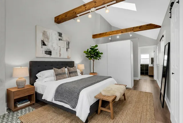 a bedroom with bed and wooden floor