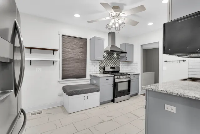 a kitchen with stainless steel appliances granite countertop a sink and a stove