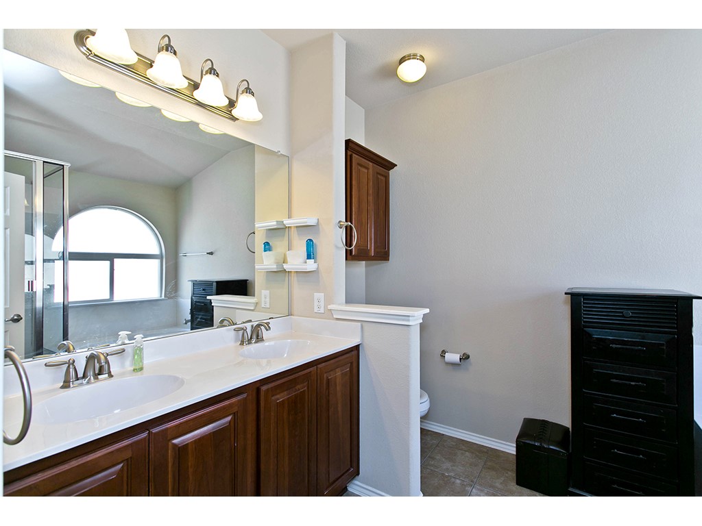 1808 Sand Creek Road Cedar Park, TX 78613 - Photo 18 of 25 Dual sink vanity with dark wood-finish cabinetry and white countertop