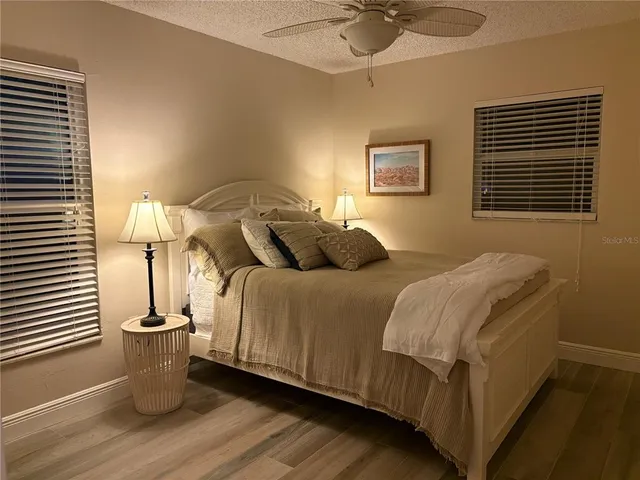 a bedroom with a large bed and a chandelier