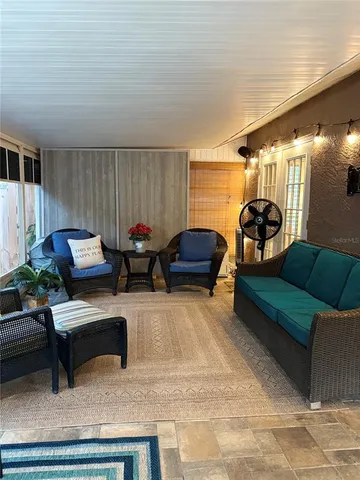 a living room with furniture and a lamp