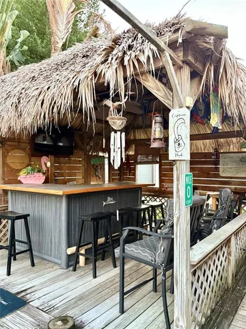 a view of a patio with table and chairs with wooden floor and fence