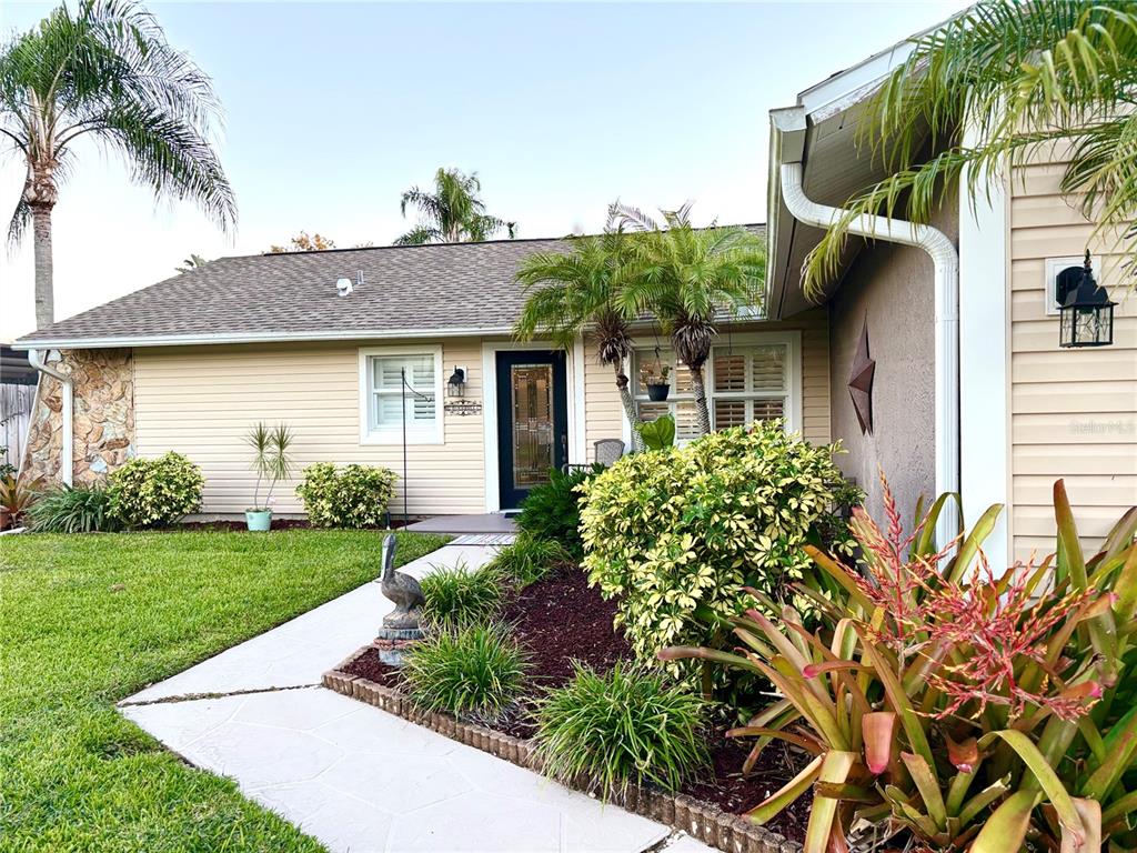 802 Woodhill Court Palm Harbor, FL 34683 - Photo 2 of 20 a front view of a house with a garden
