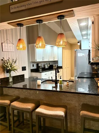 a kitchen with stainless steel appliances granite countertop a sink and a stove