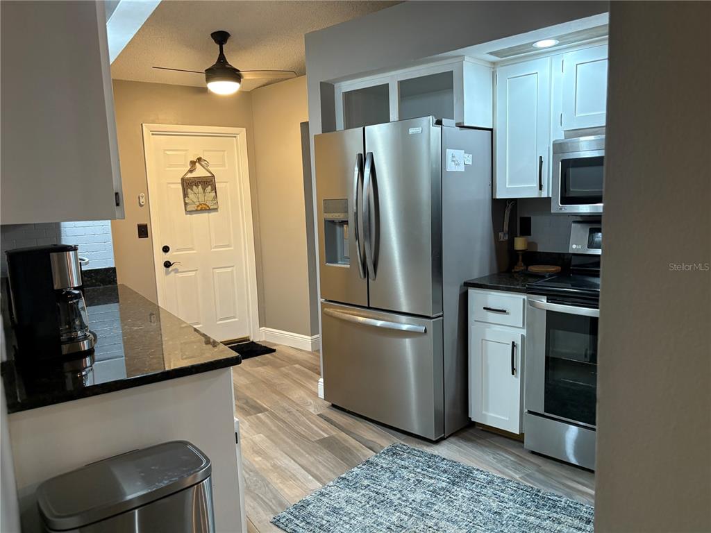 802 Woodhill Court Palm Harbor, FL 34683 - Photo 8 of 20 a kitchen with stainless steel appliances a refrigerator stove and sink