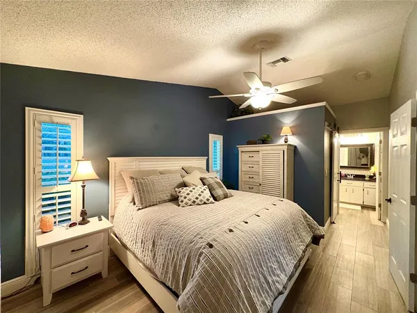 a bed room with a bed and a chandelier