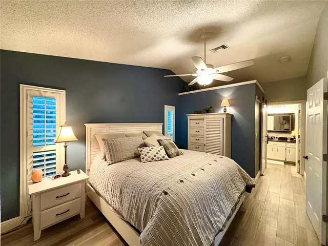 a bed room with a bed and a chandelier