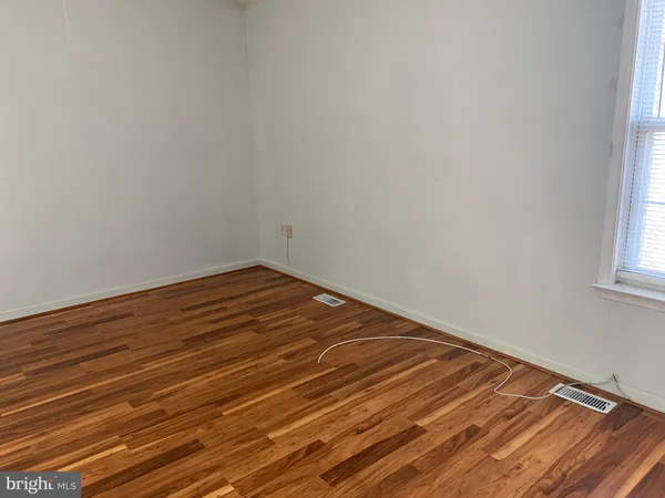 a view of room with wooden floor and fan