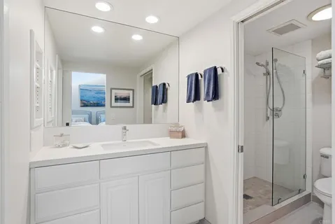 a bathroom with a sink a toilet and shower