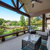 a balcony with furniture and a floor to ceiling window