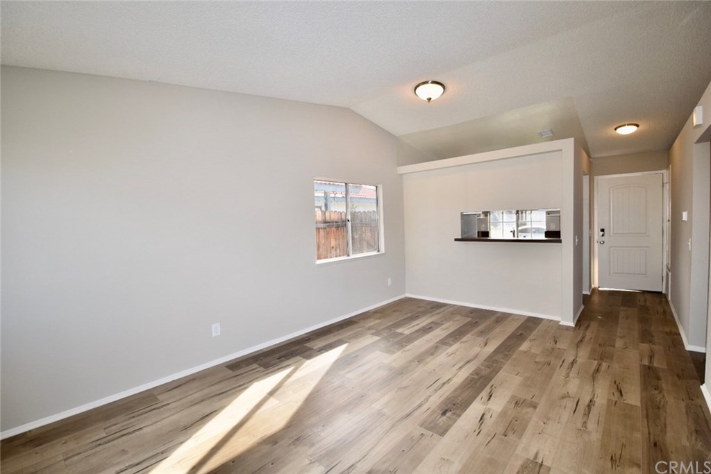740 Atchison Street Colton, CA 92324 - Photo 11 of 15 a view of empty room with wooden floor and window