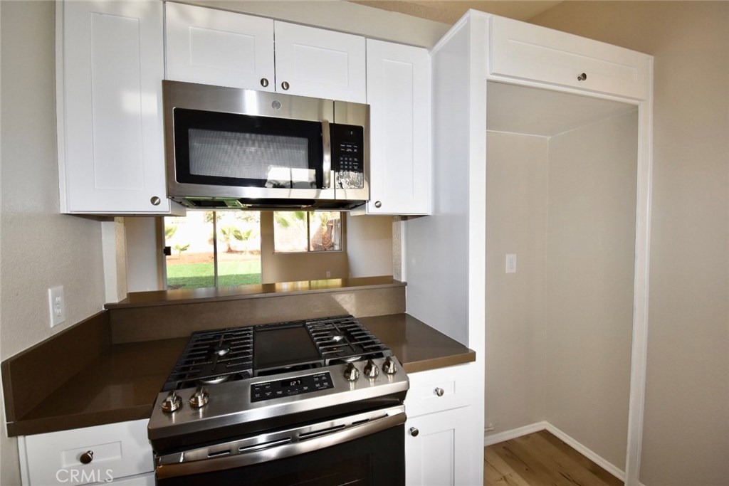 740 Atchison Street Colton, CA 92324 - Photo 13 of 15 a stove top oven sitting inside of a kitchen