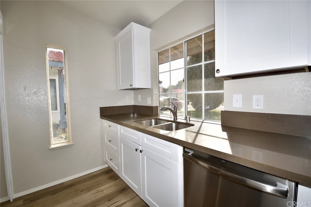 740 Atchison Street Colton, CA 92324 - Photo 3 of 15 a kitchen with stainless steel appliances a sink stove and cabinets