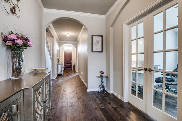 a view of a hallway with wooden floor and staircase