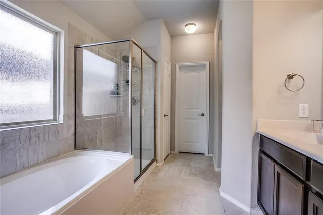 a bathroom with a shower and a sink