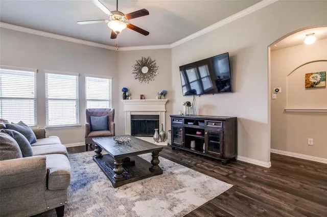 a living room with furniture a fireplace and a flat screen tv
