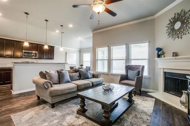 a living room with furniture a fireplace and a flat screen tv