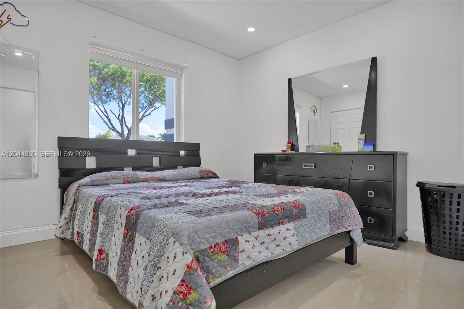 12551 Southwest 223rd Street Miami, FL 33170 - Photo 13 of 35 a bedroom with a bed and a dresser