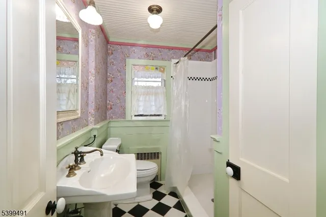 a bathroom with a sink mirror and a bathtub