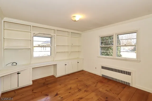 a view of a kitchen with wooden cabinet and floors