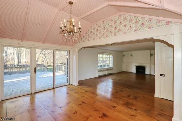 a view of a room with wooden floor and chandelier