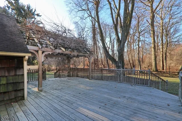 a view of outdoor space with wooden floor and large trees