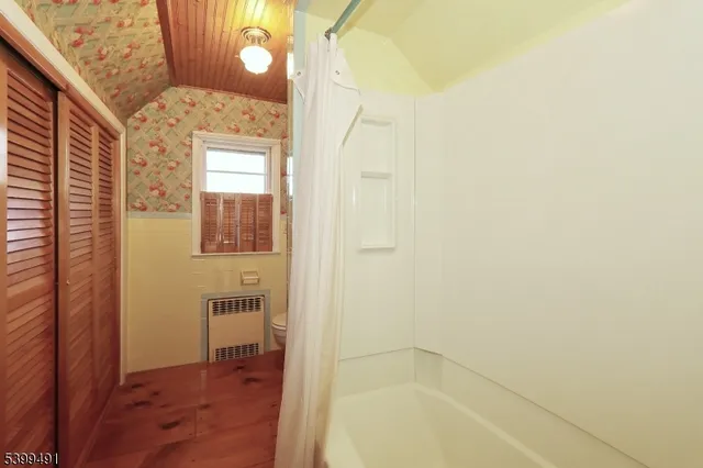 a bathroom with a bathtub and shower