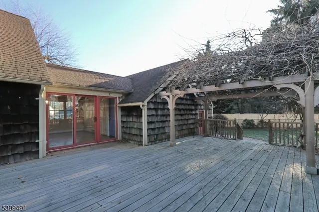 a view of house with deck and outdoor space