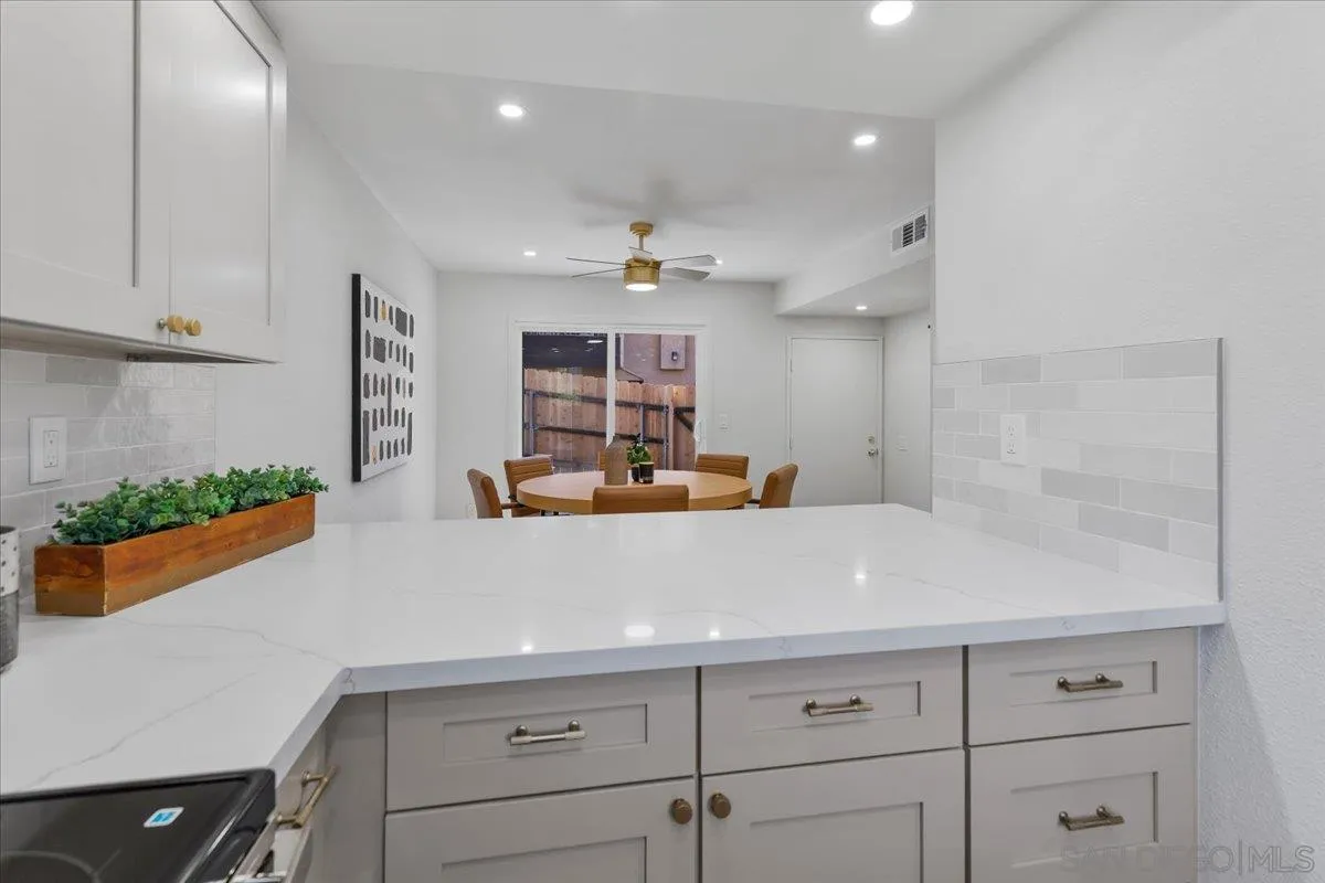1572 Stone Edge Circle El Cajon, CA 92021 - Photo 13 of 34 a view of a kitchen with kitchen island a potted plant on the counter