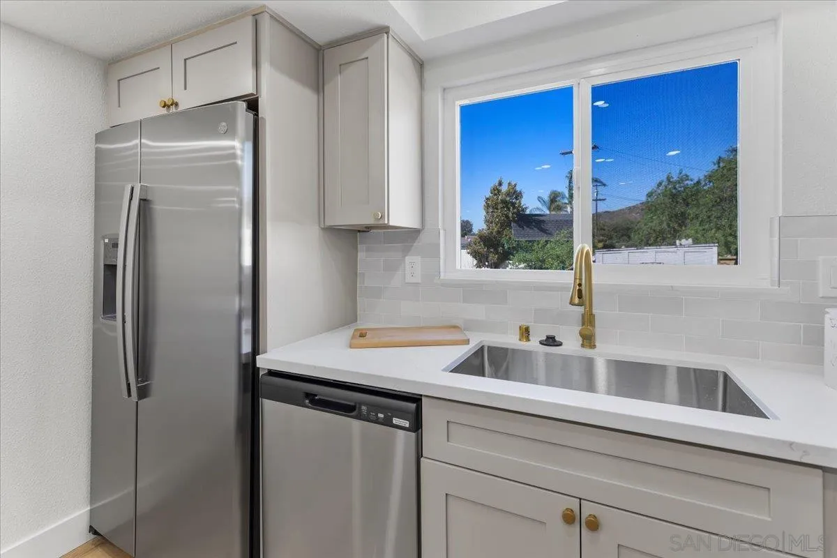 1572 Stone Edge Circle El Cajon, CA 92021 - Photo 14 of 34 a kitchen with stainless steel appliances granite countertop a refrigerator and a sink