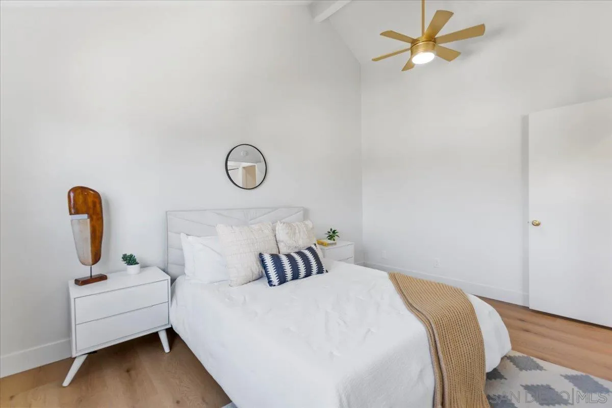 1572 Stone Edge Circle El Cajon, CA 92021 - Photo 19 of 34 a bedroom with a bed and a table with wooden floor