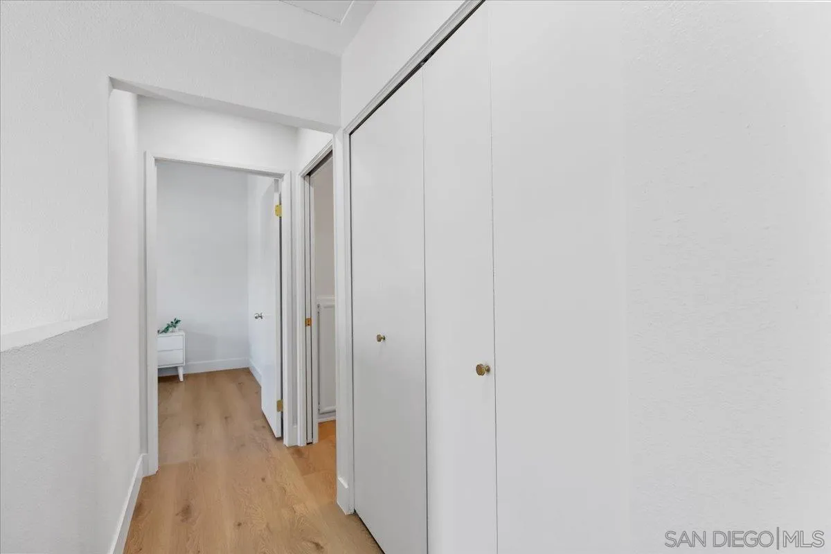 1572 Stone Edge Circle El Cajon, CA 92021 - Photo 22 of 34 a view of a hallway with wooden floor and a bathroom