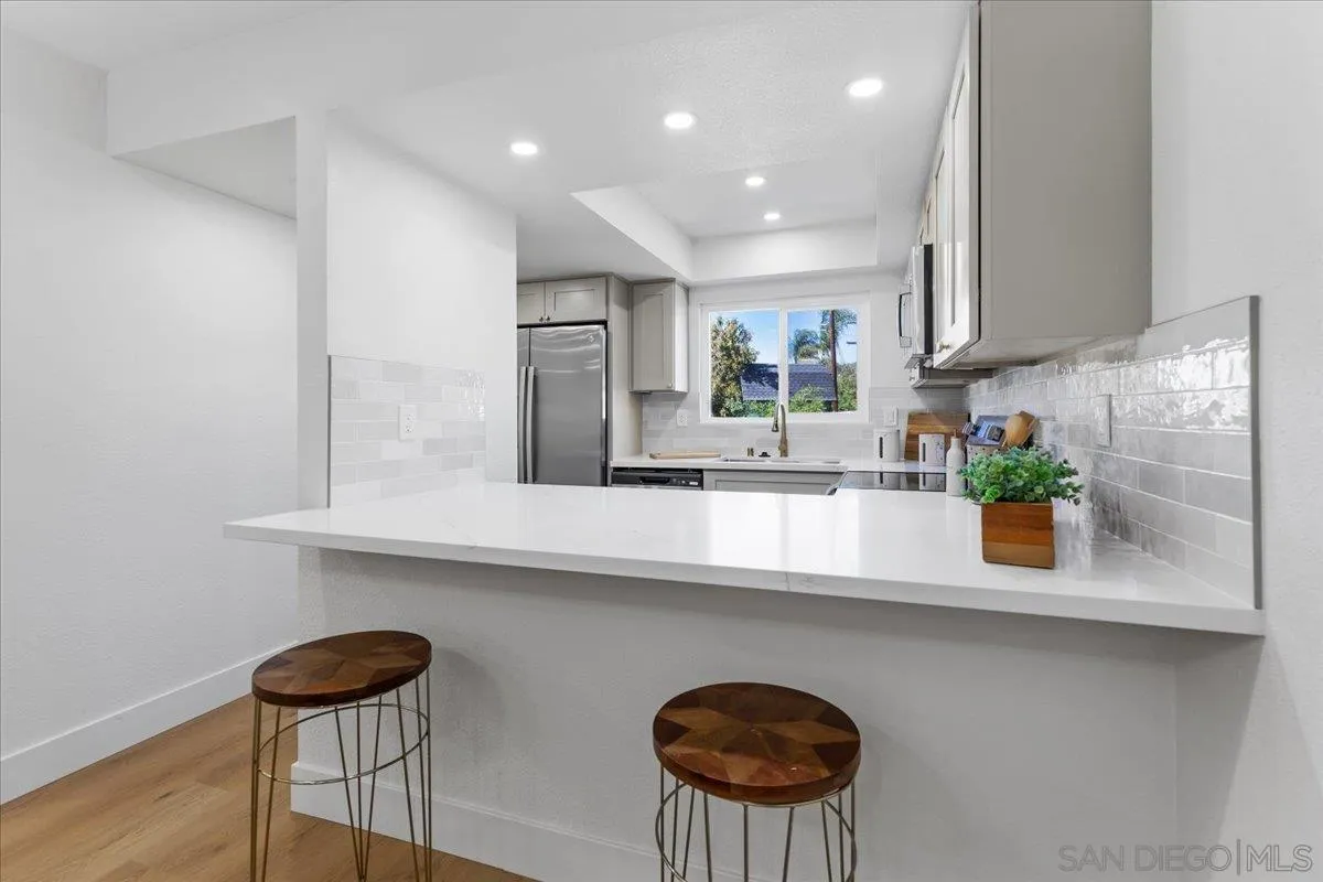 1572 Stone Edge Circle El Cajon, CA 92021 - Photo 4 of 34 a kitchen with stainless steel appliances granite countertop a sink a stove and a wooden floors