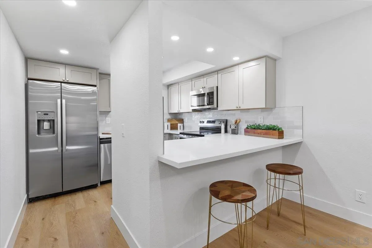 1572 Stone Edge Circle El Cajon, CA 92021 - Photo 10 of 34 a kitchen with stainless steel appliances granite countertop a sink a refrigerator and a stove