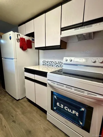a kitchen with stainless steel appliances a refrigerator a stove and cabinets