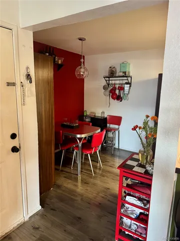 a dining room with furniture and wooden floor
