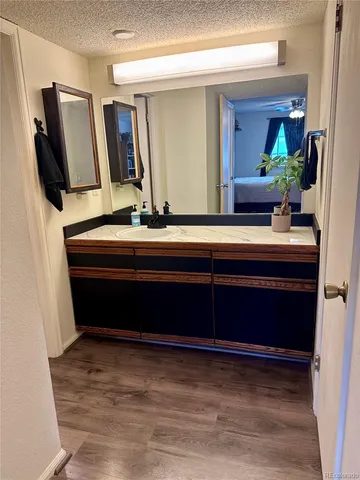 a room with a refrigerator and mirror