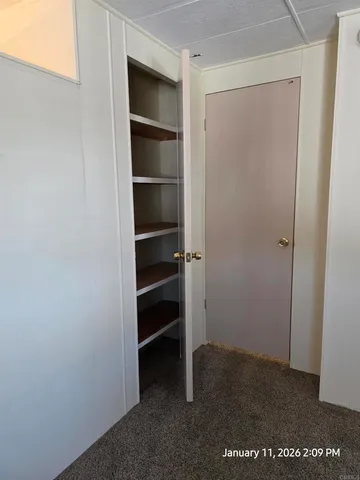 a view of a patio with table and chairs potted plants