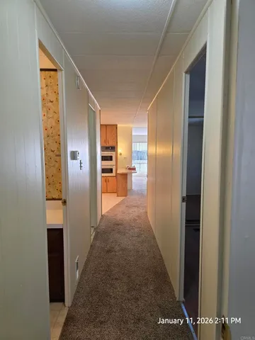 a kitchen with a refrigerator and a stove top oven