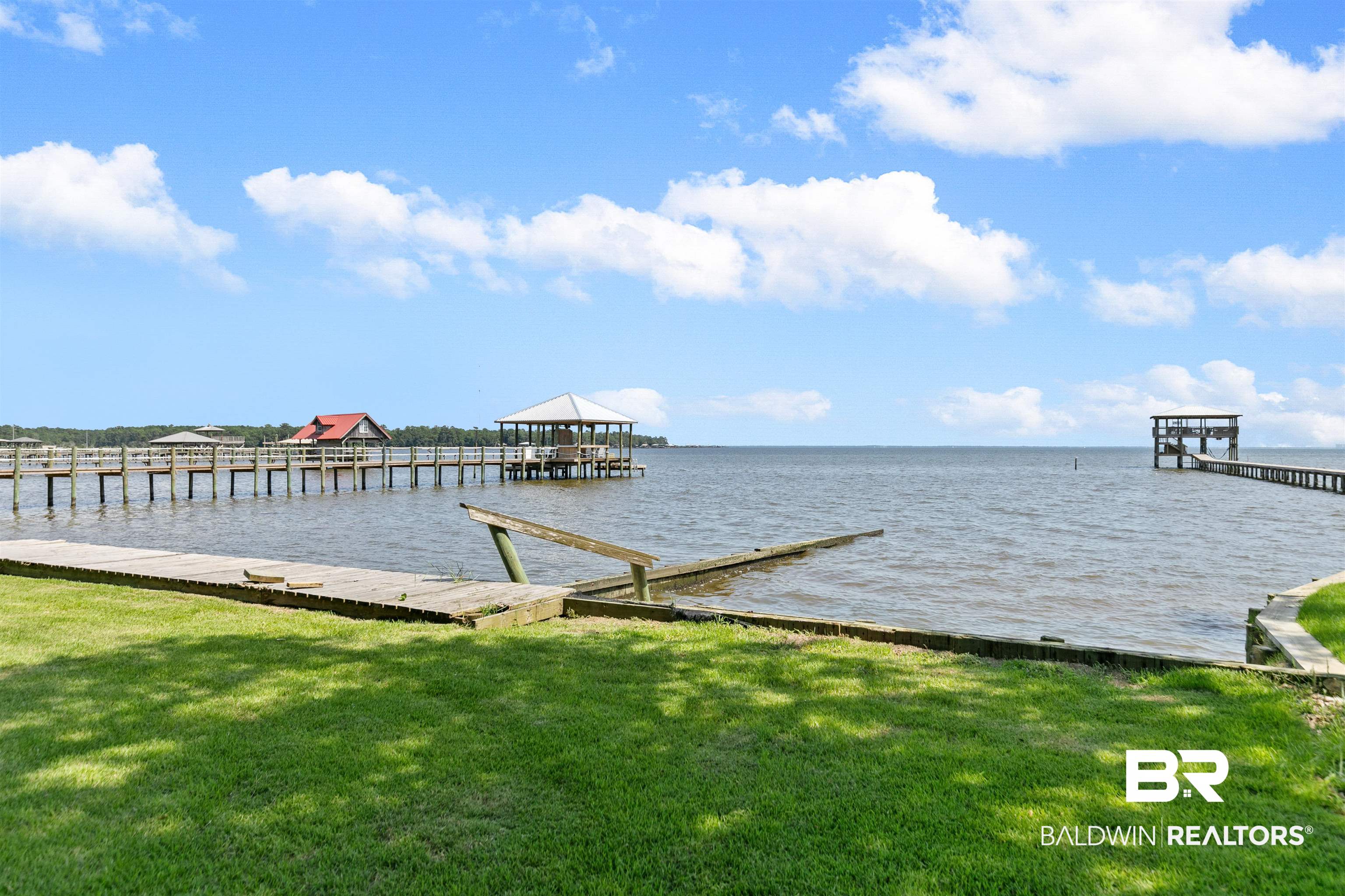 10507 County Road 1 Fairhope, AL 36532 - Photo 38 of 59 Dock area featuring a water view and a lawn