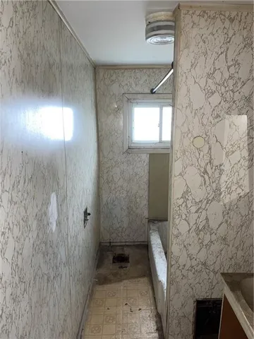 a view of a livingroom with an empty space and a window