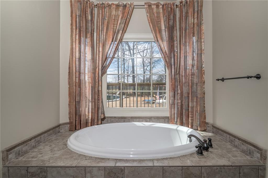 723 Sulphur Springs Road Southeast Fairmount, GA 30139 - Photo 22 of 54 a white bath tub sitting in a bathroom next to a window