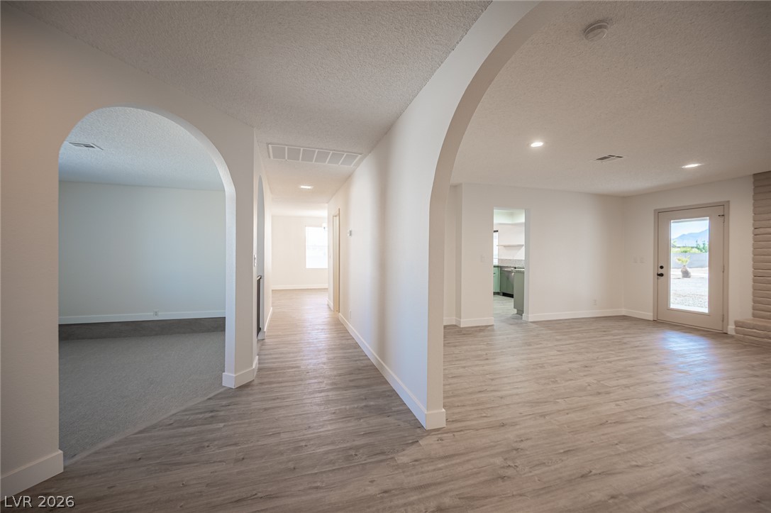 7041 North Decatur Boulevard Las Vegas, NV 89131 - Photo 12 of 33 Archways lead through this inviting interior, showcasing fresh flooring and ample natural light.
