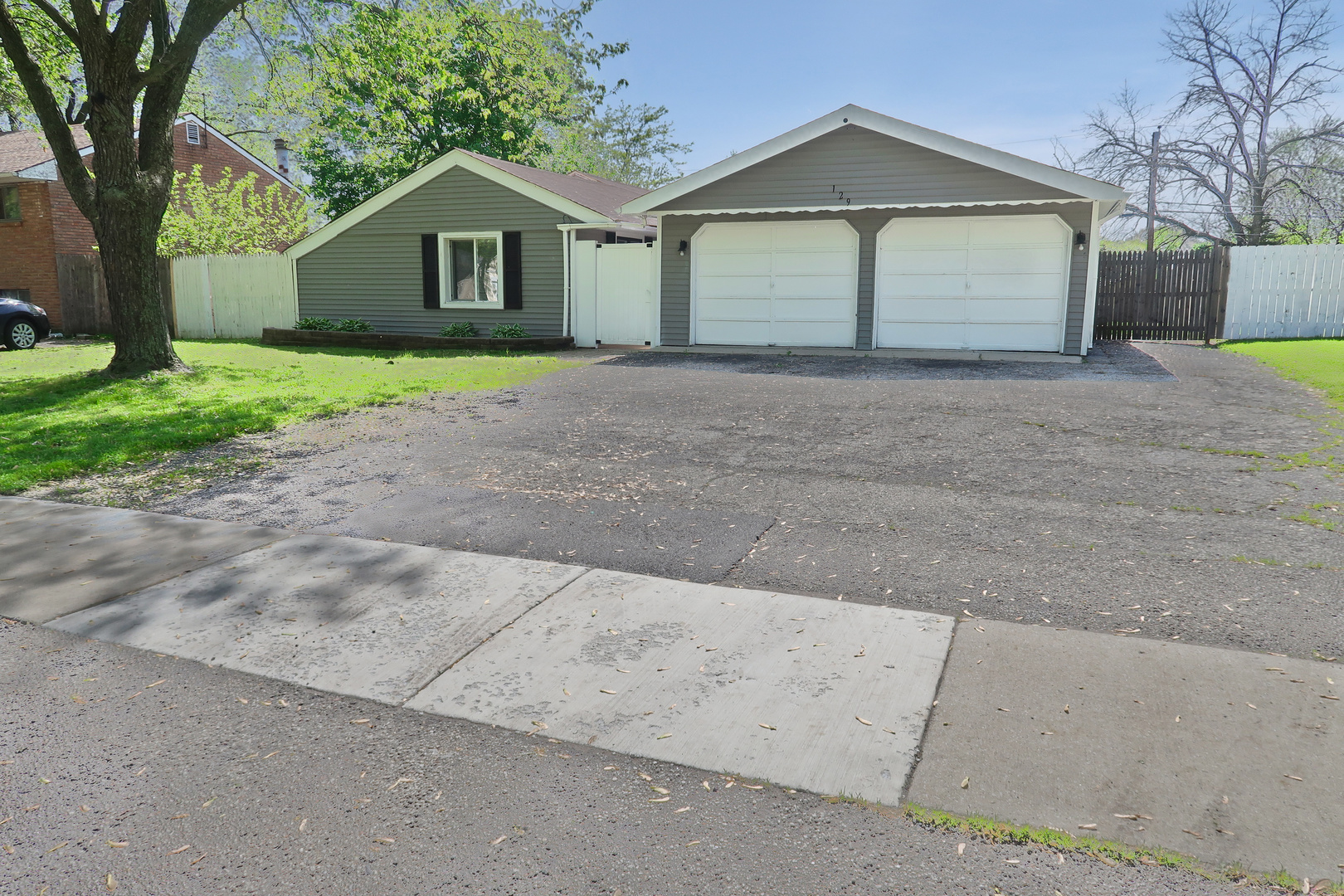 129 Kingston Road Bolingbrook, IL 60440 - Photo 2 of 37 a front view of house with yard and trees