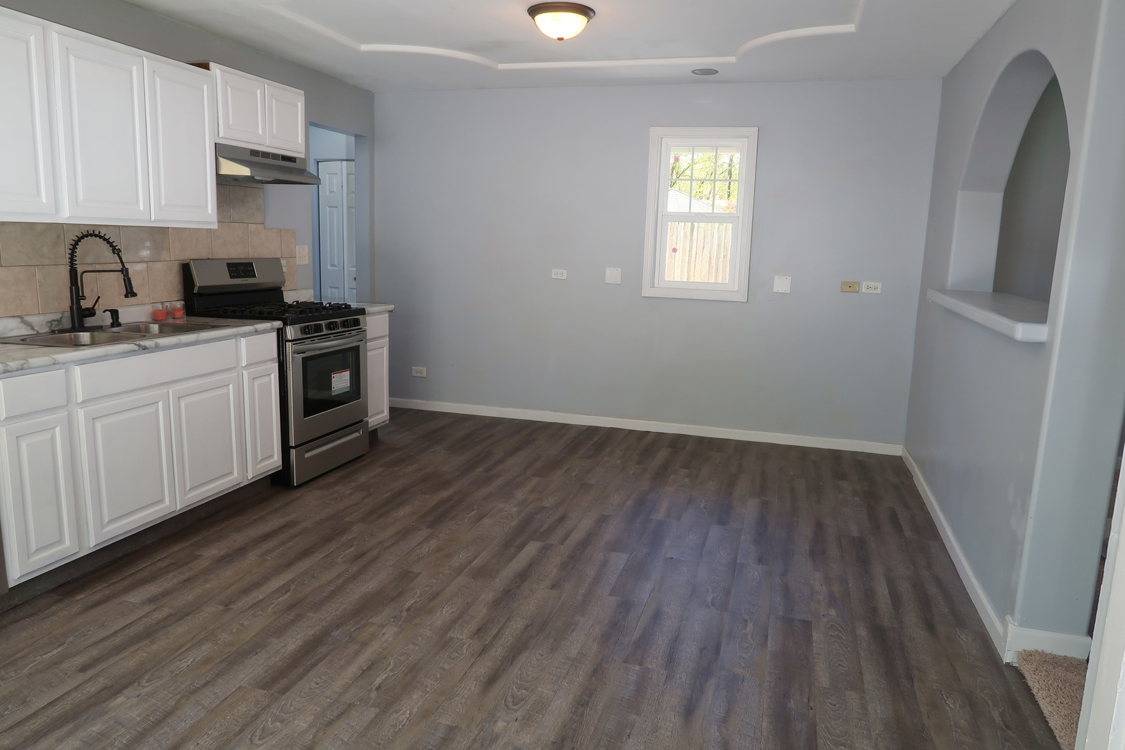 129 Kingston Road Bolingbrook, IL 60440 - Photo 12 of 37 a kitchen with wooden floors and white appliances