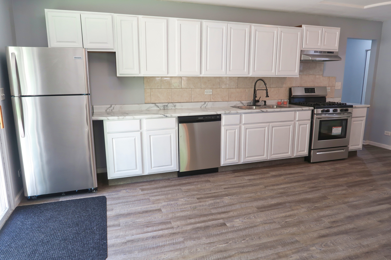 129 Kingston Road Bolingbrook, IL 60440 - Photo 13 of 37 a kitchen with stainless steel appliances a refrigerator sink and cabinets