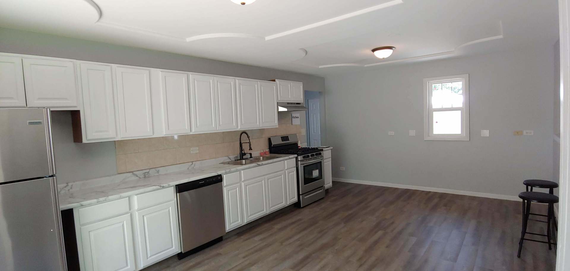 129 Kingston Road Bolingbrook, IL 60440 - Photo 14 of 37 a kitchen with a sink cabinets and wooden floor