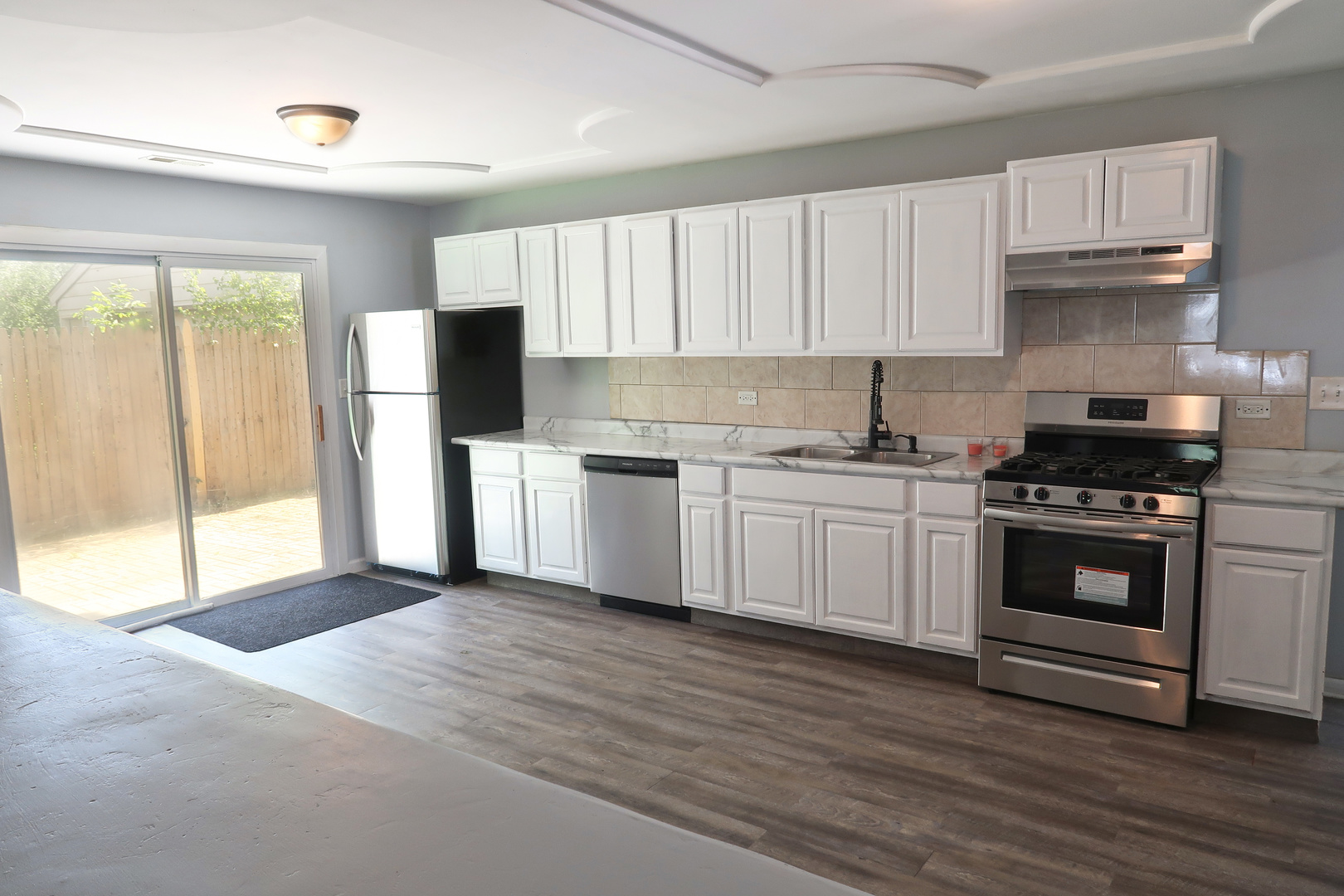 129 Kingston Road Bolingbrook, IL 60440 - Photo 15 of 37 a kitchen with a white cabinets and white appliances